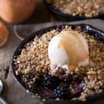 Fresh blackberries and apples showing through the crumble topping