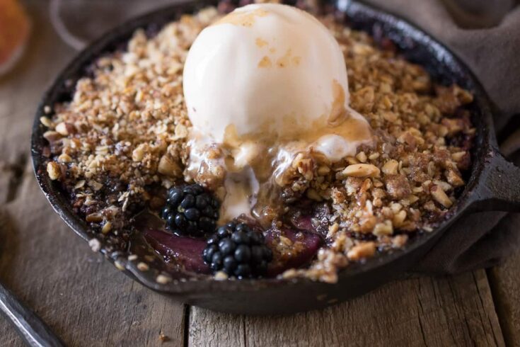 A scoop of vanilla ice cream melting into Apple spiced caramel sauce
