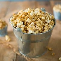 A silver bucket of of apple cider caramel popcorn