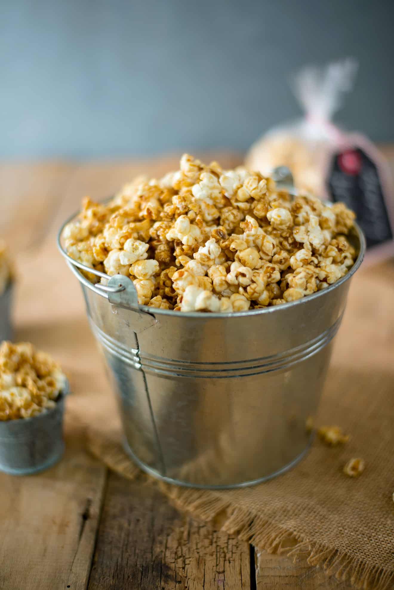 A silver bucket filled with Apple Cider Caramel Popcorn