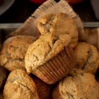 A wooden box with burlap draped over filled with apple pie pecan muffins
