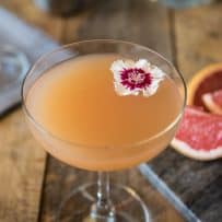 The drink from overhead showing the pretty red and white flower garnish