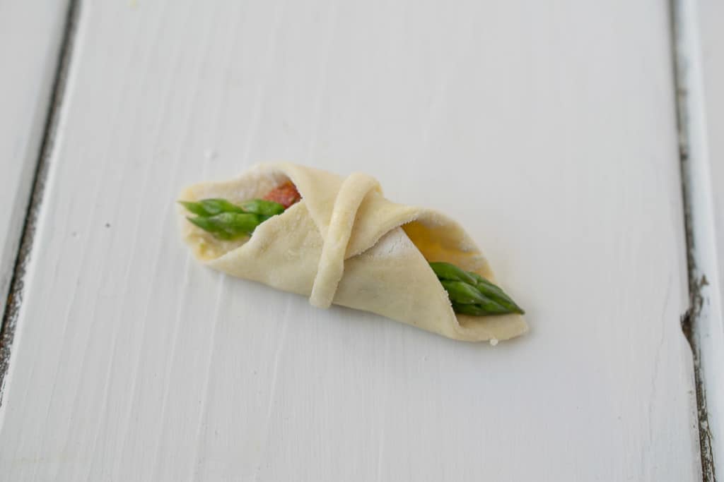 A puff pastry bite ready to go in the oven