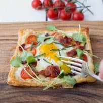 Cutting into the egg yolk that is running over the rest of the tart