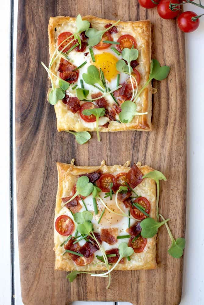 2 bacon egg and tomato puff pastry tarts viewed from overhead