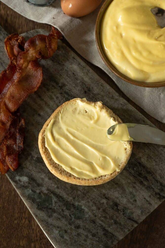 Bacon mayonnaise spread on a burger bun