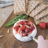 Cutting into the baked brie