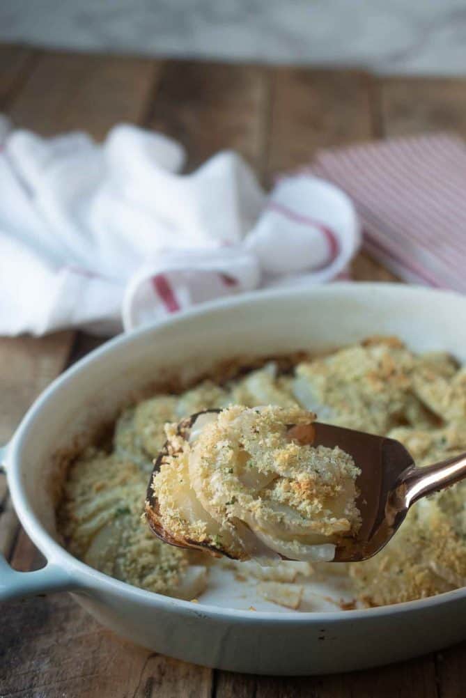 A spatula scooping up baked fennel and apple