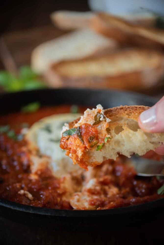 Ciabatta bread dipped in goat cheese and marinara