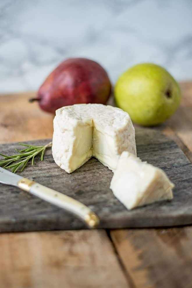 A block of good goat cheese with a knife