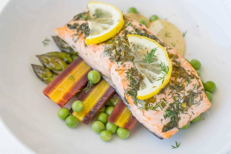 A closeup showing fresh lemon slices and dill