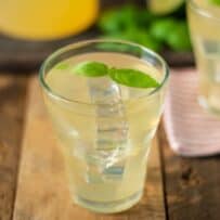 A short glass of basil ginger lime tea