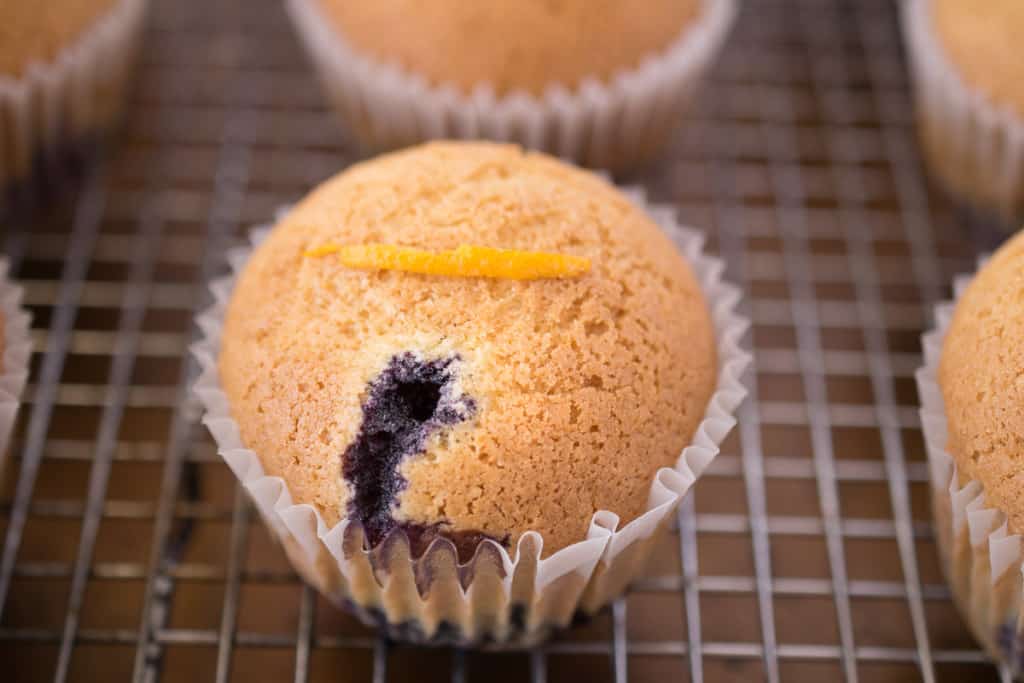 Blueberry orange upside down muffin on a cooling rack