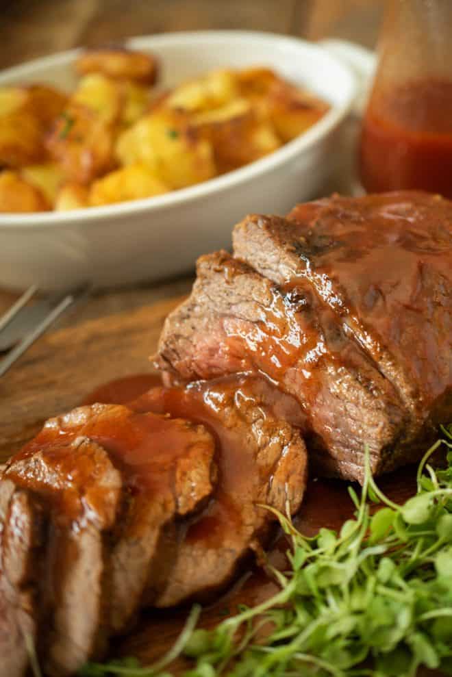 A closeup of the bbq sauce poured over the perfectly cooked meat