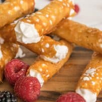 A closeup of a Brandy Snap showing the lacy pattern and cream filling
