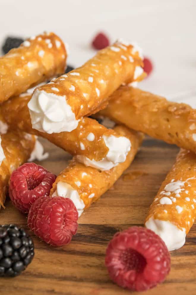 A closeup of a Brandy Snap showing the lacy pattern and cream filling