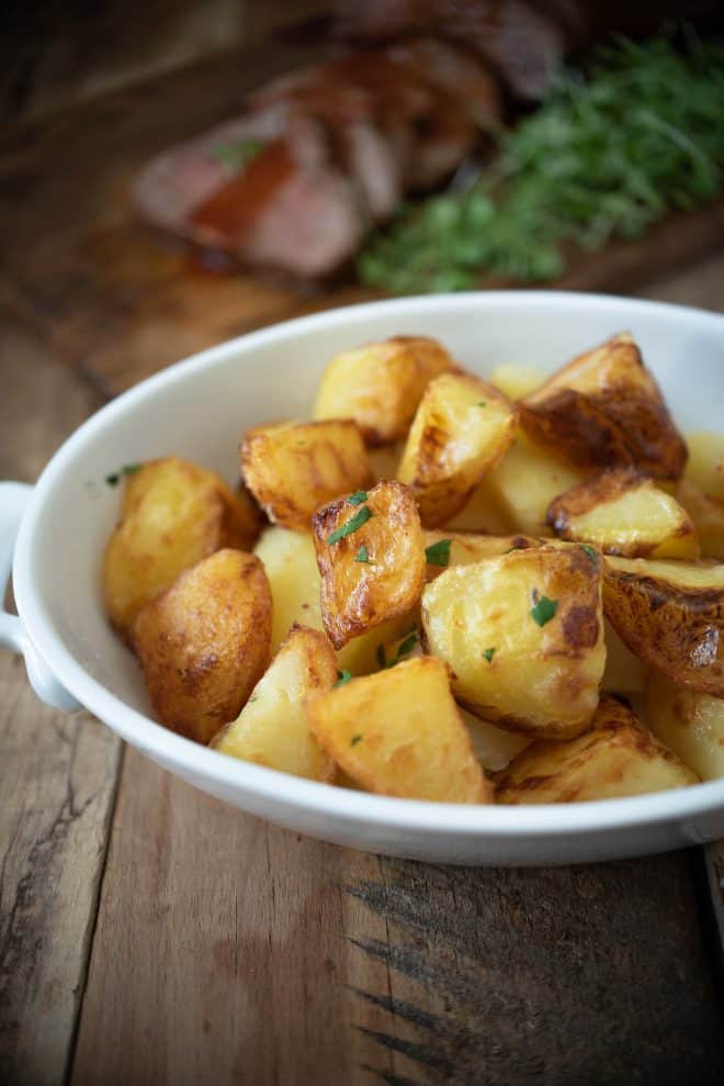 British roast potatoes - roasties fresh out of the oven in a serving dish