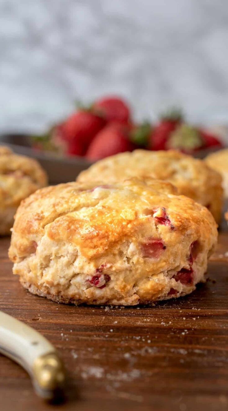A golden brown, flaky scone made filled with fresh strawberries