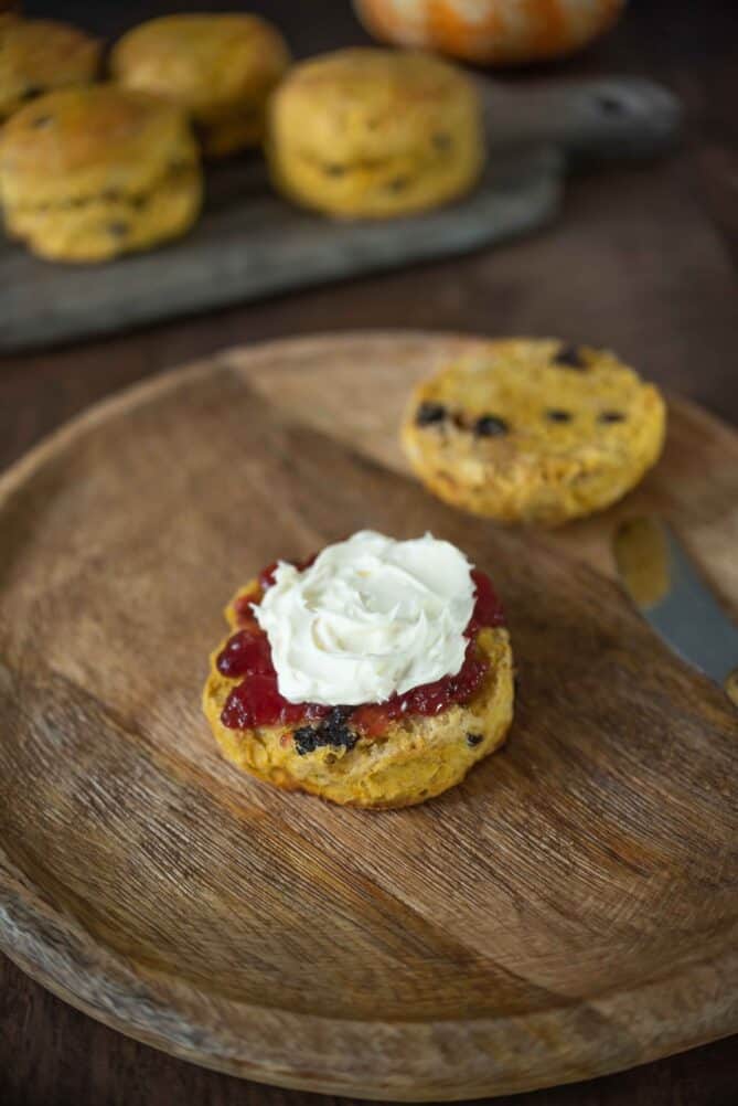 Creamy clotted cream and strawberry jam on top of a British scone