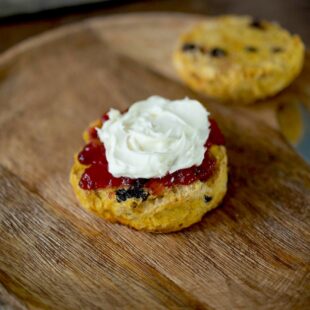 A British style pumpkin scone with a knife on a plate