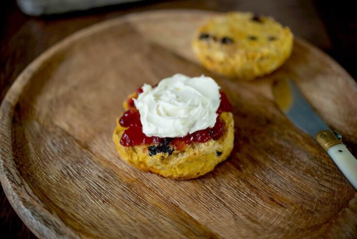 A British style pumpkin scone with a knife on a plate