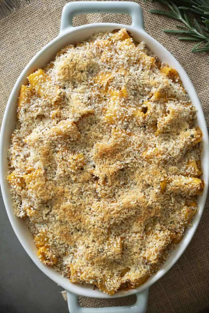 An oval dish filled with pasta baked in sweet potato sauce