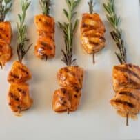 6 pieces of grilled chicken on rosemary skewers