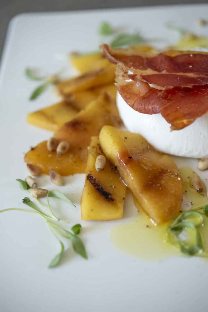 A closeup of peach slices that were charred on the grill