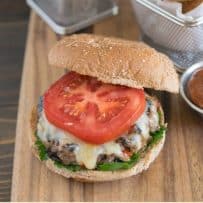 The burger showing the melted cheese and tomato