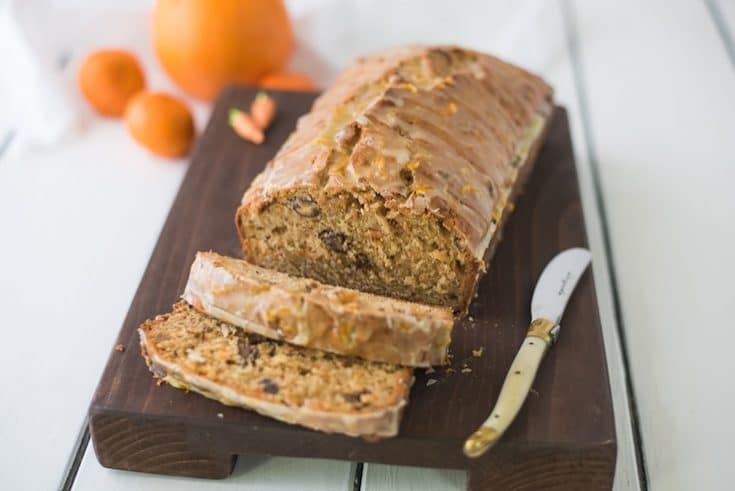 Carrot ginger spiced bread on a board with a knife and slices