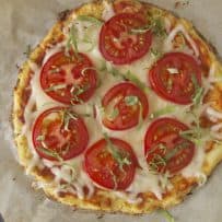 Cauliflower crust tomato basil pizza viewed from overhead