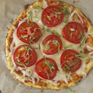Cauliflower crust tomato basil pizza viewed from overhead