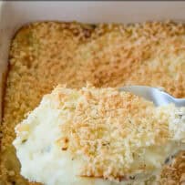 Creamy mashed potatoes with a panko breadcrumb topping on a serving spoon