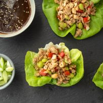Ground chicken and vegetables in lettuce with orange sauce