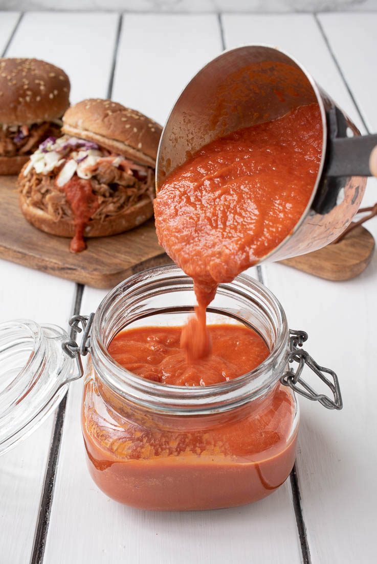 Pouring the bbq sauce into a jar