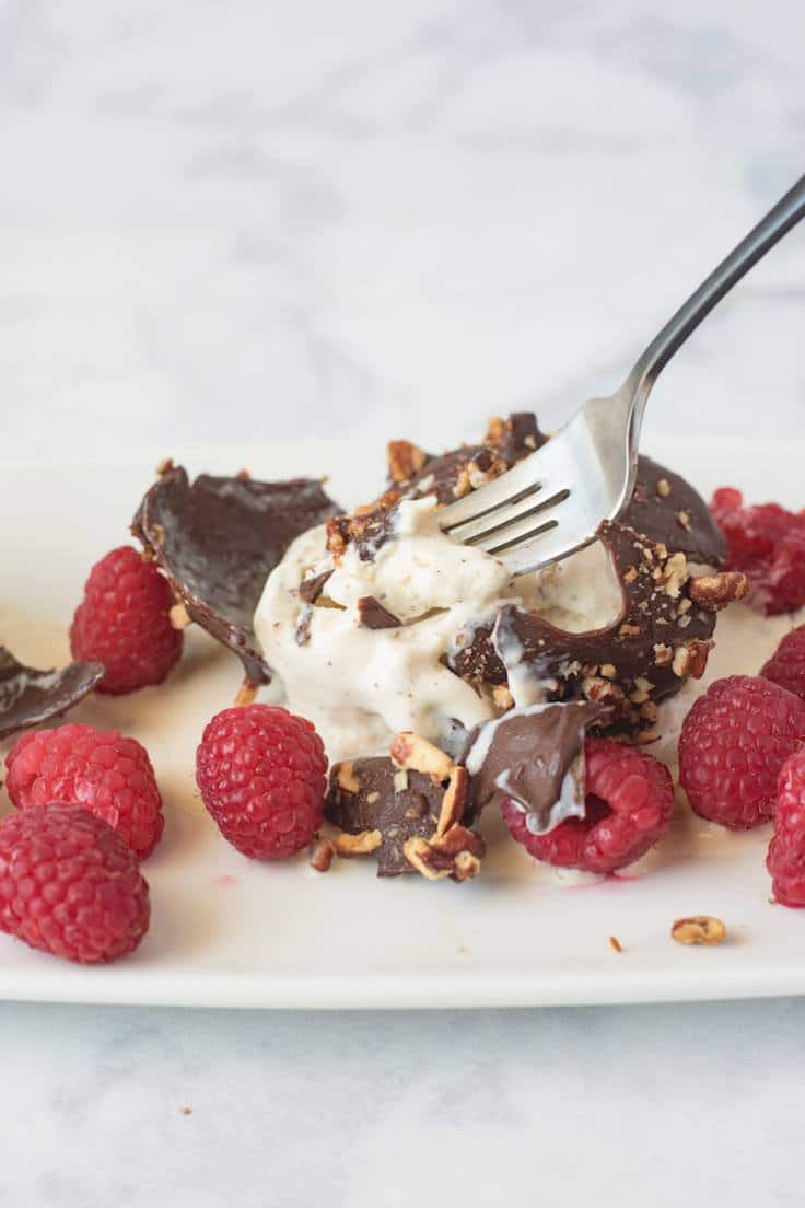 Cracking open the crispy chocolate to get to the ice cream