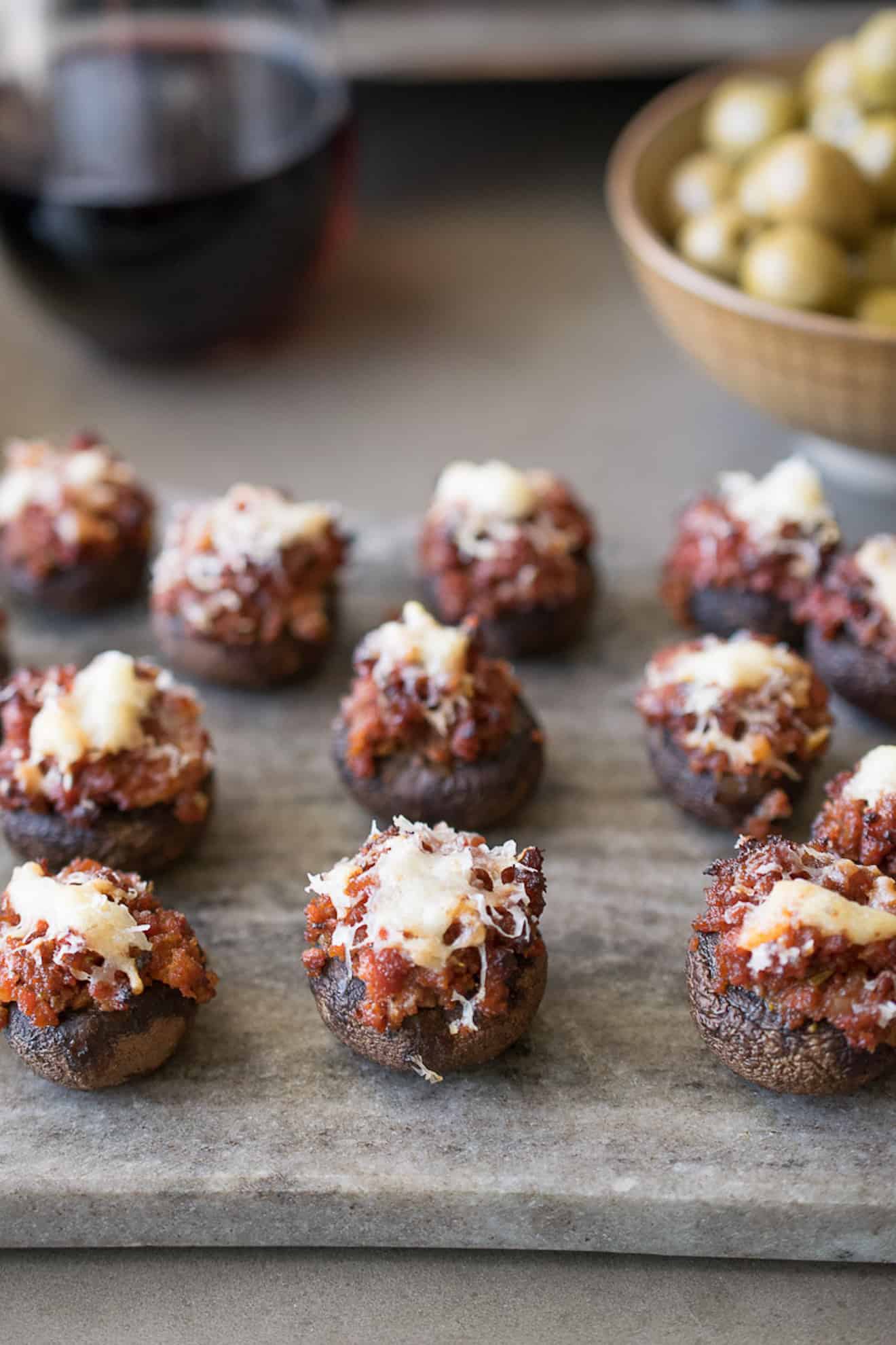 Chorizo stuffed mushrooms on a grey serving platter