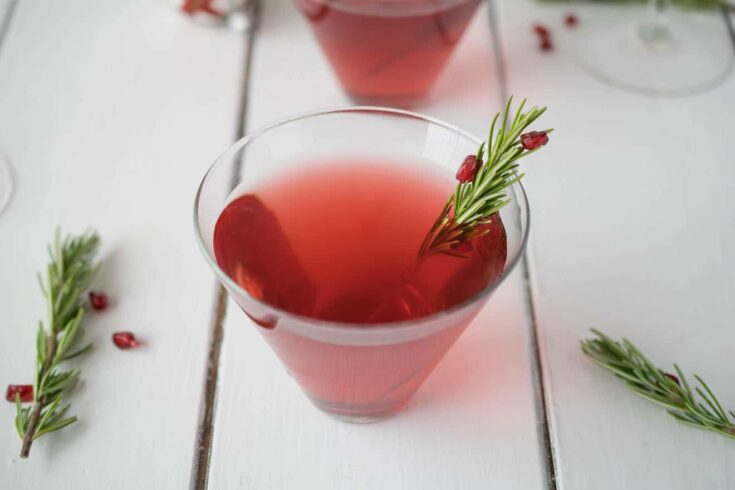 Christmas Cosmopolitan in a glass with fresh rosemary
