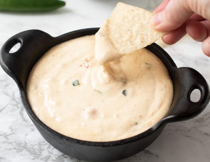 Using a tortilla dip to dip into queso blanco