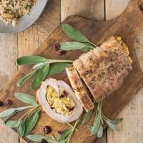Sliced stuffed pork loin showing the cornbread apple and cranberry stuffing