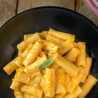 Vibrant orange butternut squash sauce mixed with pasta