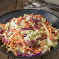 Colorful coleslaw in a black bowl