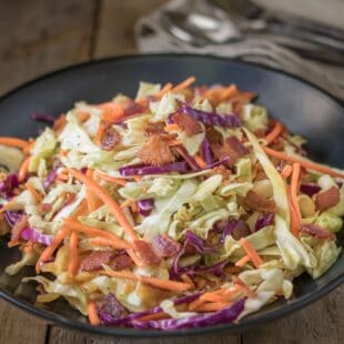 Colorful coleslaw in a black bowl