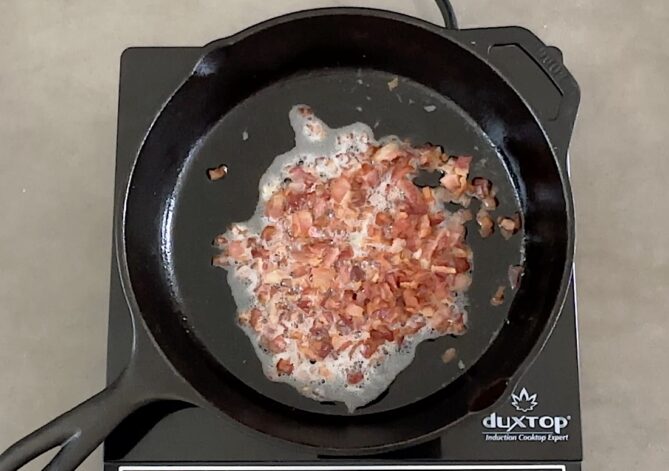 Cooking bacon pieces in a pan