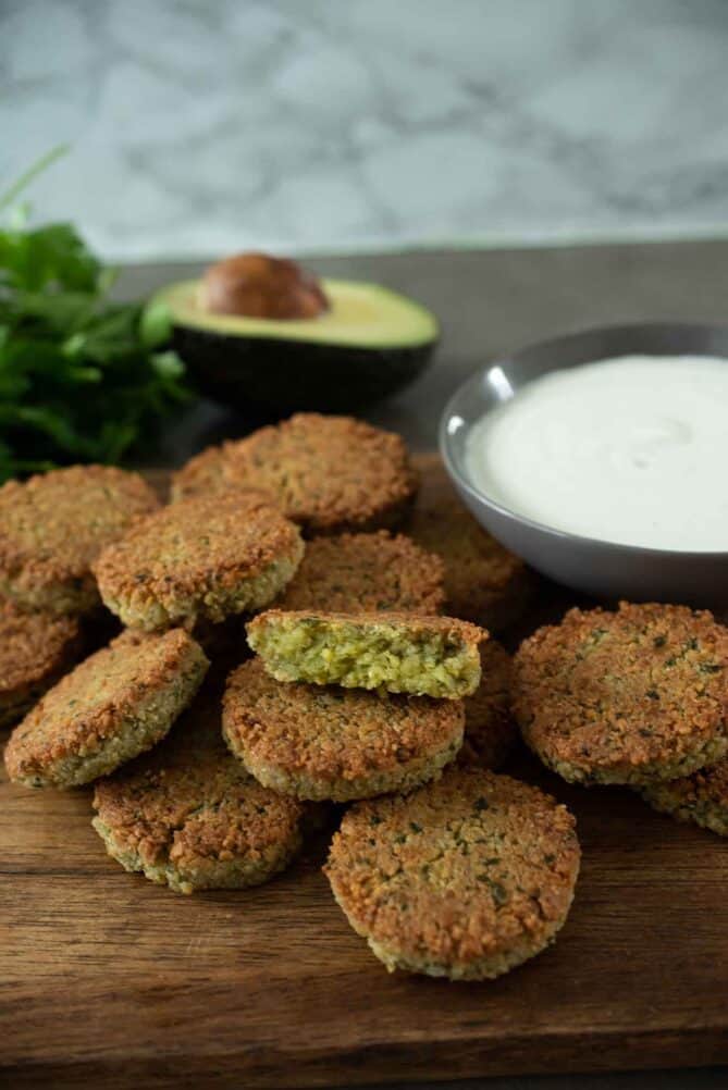 A stack of falafel served with yogurt tahini sauce