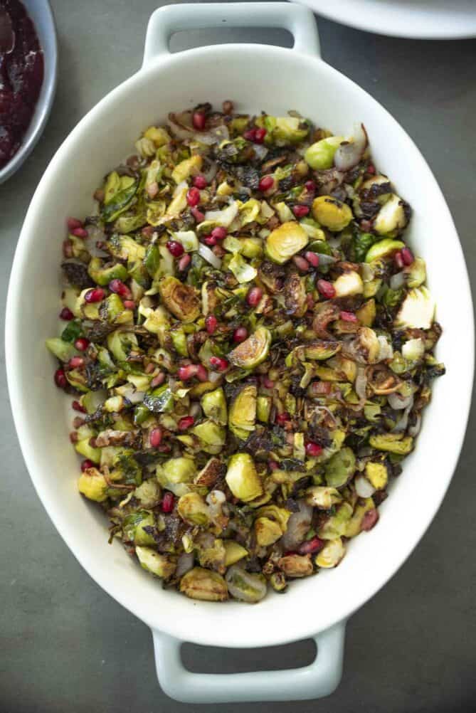 An oval dish viewed from overhead filled with crispy shredded Brussels sprouts