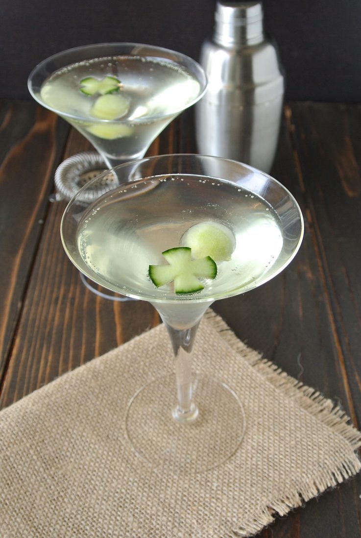 2 martini glasses of cucumber gin fizz garnished with cucumber