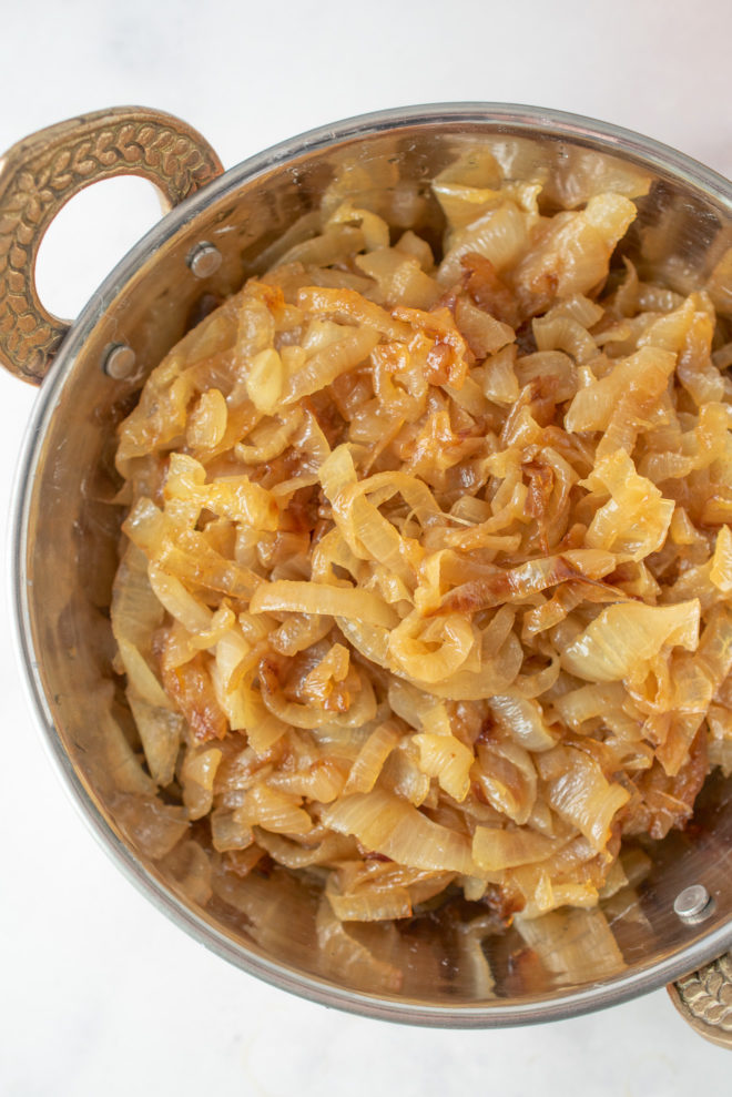 A closeup of curry caramelized onions showing the deep brown color