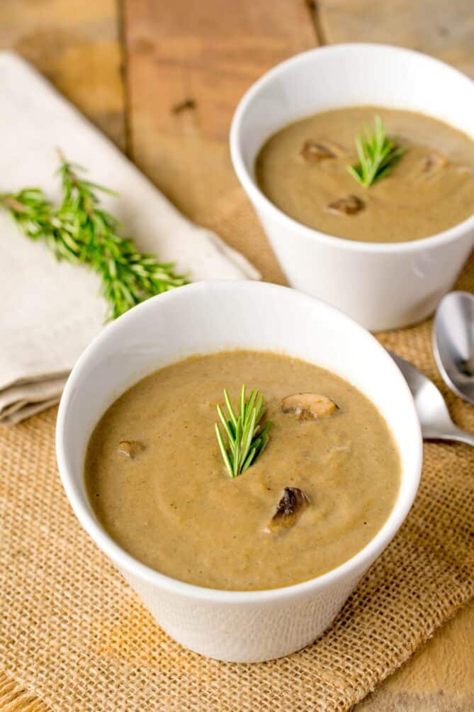 2 angled white bowls of mushroom soup