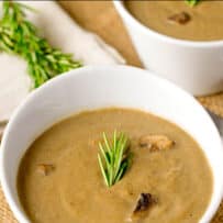 Dairy free mushroom soup in a white bowl with chunks of mushrooms
